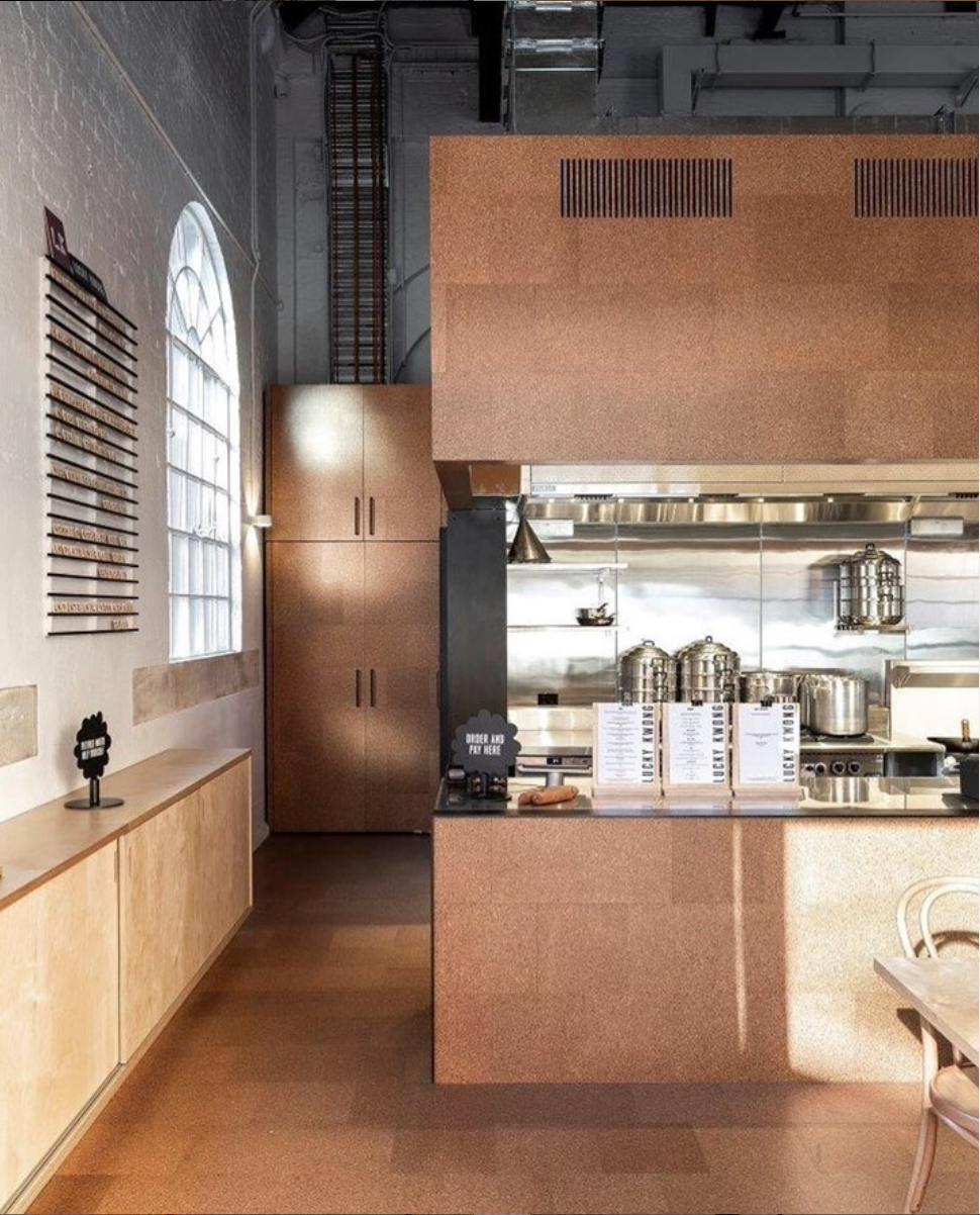 Modern café kitchen with cork-clad countertops, stainless steel appliances